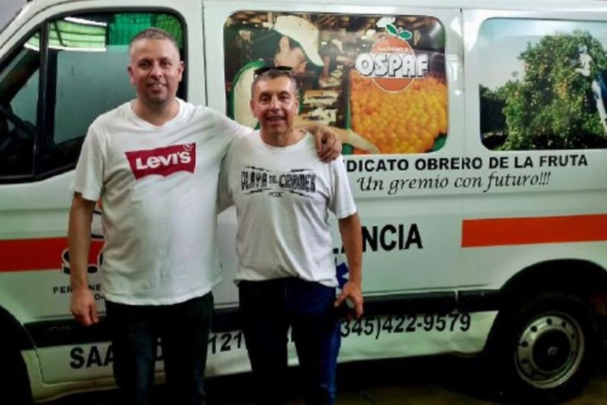 Ivan Amaro (derecha) posando frente a uno de los veh&iacute;culos en la sede del gremio.